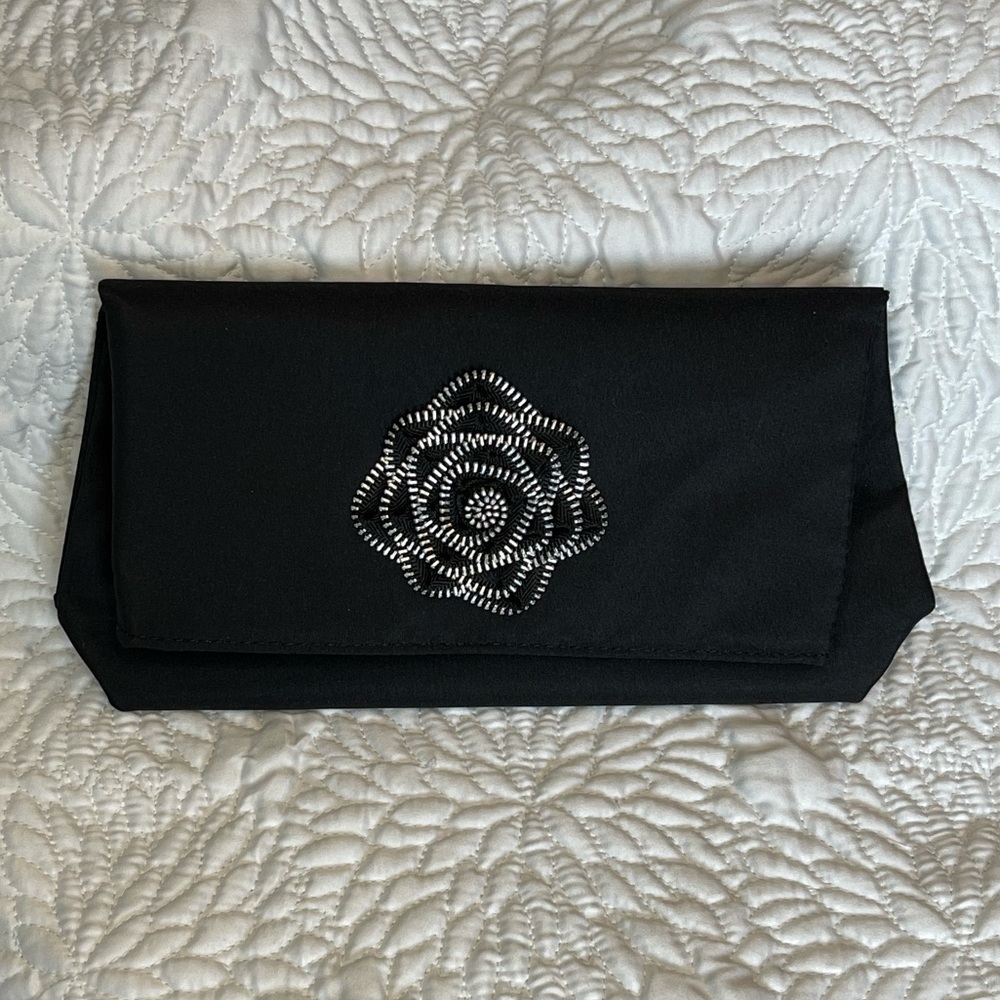 Black clutch w/edgy rose. Can be used as purse & makeup bag. Snaps & folds over